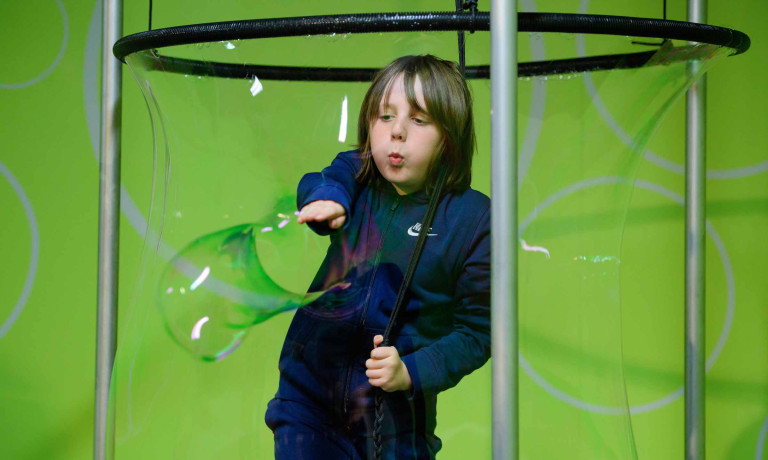 Chris Vaughan - case study images: MathsCity | A youngster bursts a bubble that has surrounded him.