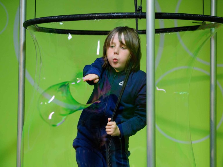 Chris Vaughan - case study images: MathsCity | A youngster bursts a bubble that has surrounded him.