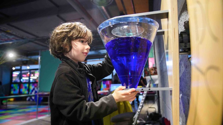 Chris Vaughan - case study images: MathsCity | A youngster carefully completes a task.