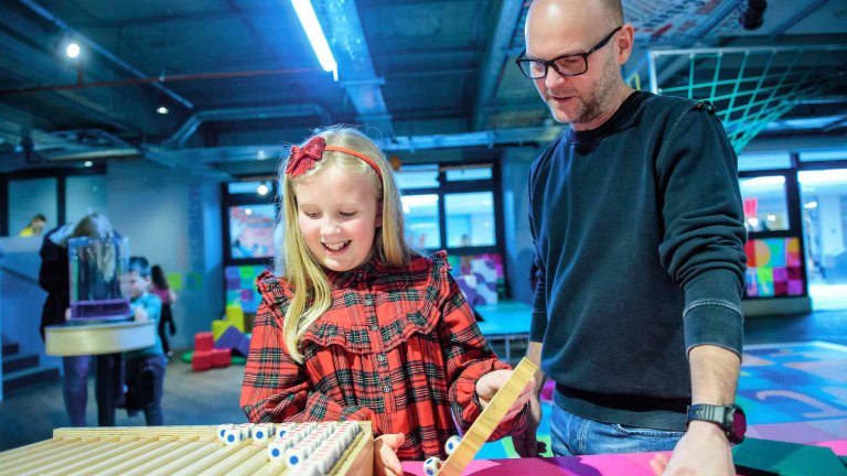 Chris Vaughan - case study images: MathsCity | A youngster, alongside their Dad, undertakes a task.