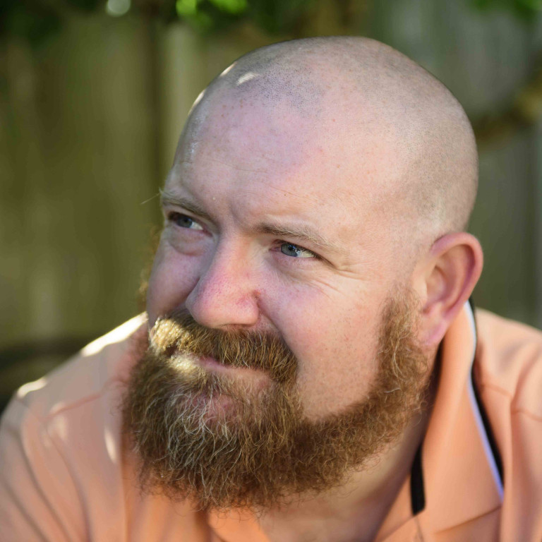 A profile picture of Chris Vaughan, owner of Chris Vaughan Photography, looking off camera.